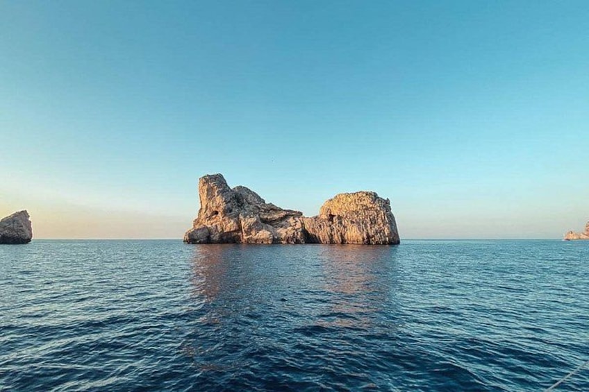 A calm sea with two rocky formations. 4