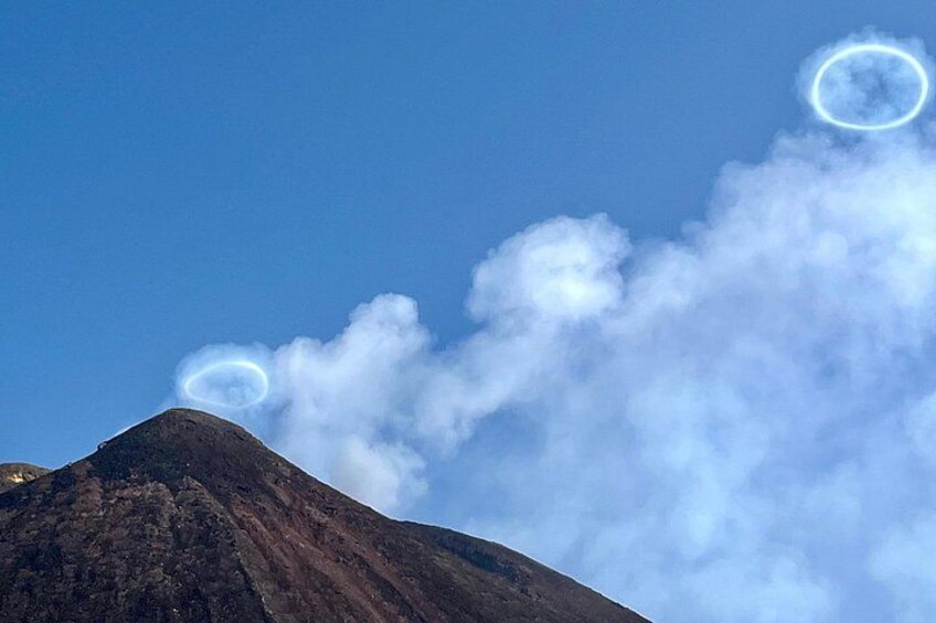 A mountain with smoke and a circular cloud formation. 3