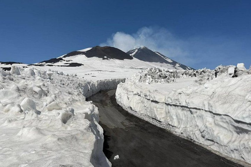 A snow-covered landscape with a glacier and a mountain in the background. 2