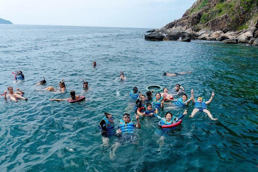 People floating on the water with life vests and tubes. 2