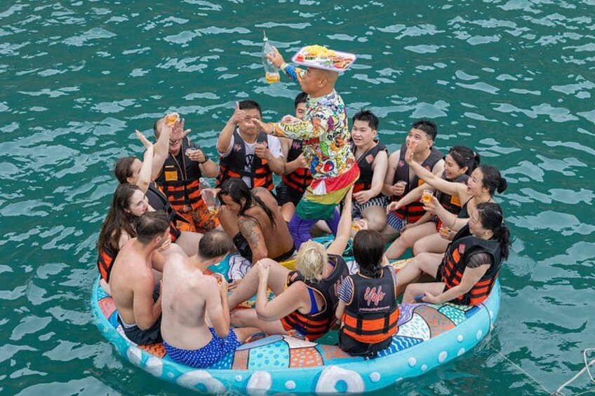 A group of people on a colorful inflatable raft in the water. 3