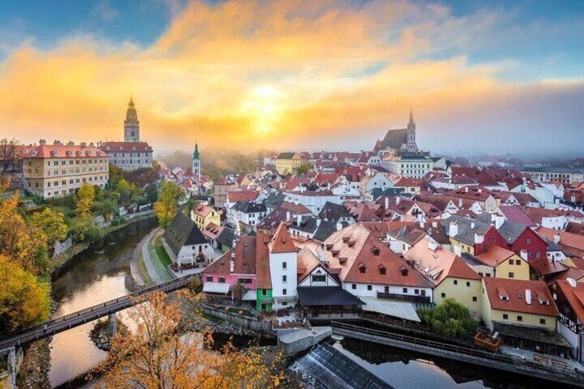 A historic town with a river, bridges, and prominent buildings including a church and a castle. 5