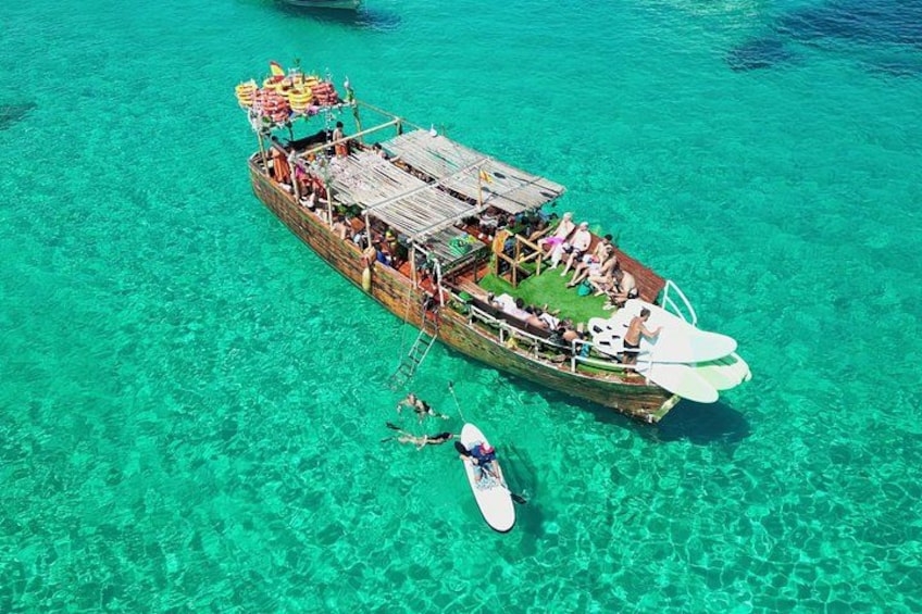 A boat with passengers and a person paddling nearby. 4