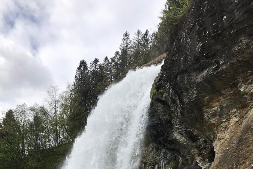 A waterfall cascading down a rocky cliff surrounded by trees. 5