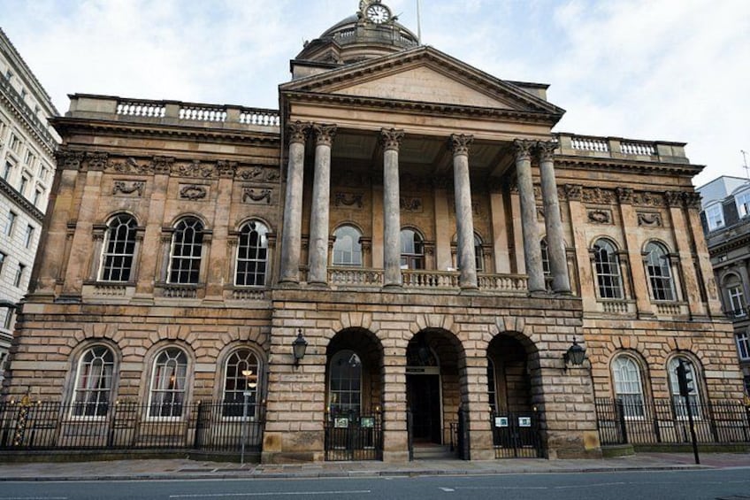 A large classical building with columns, arched windows, and a prominent entrance. 4
