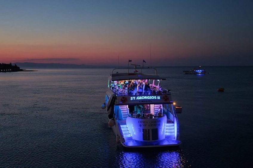 A boat with illuminated blue lights and the name 'St. Georgios II' on its front. 4