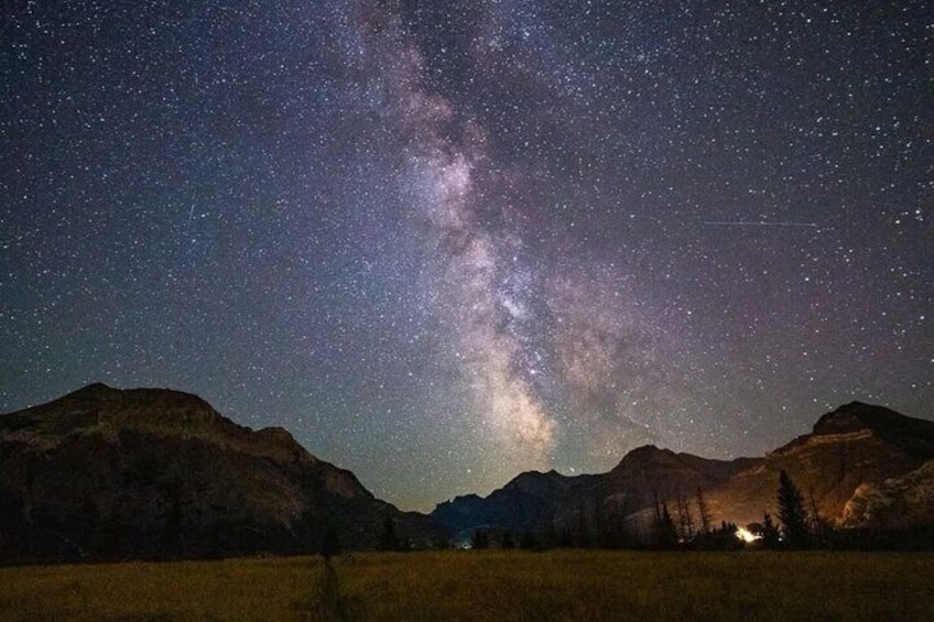 A night sky with the Milky Way over a mountainous landscape. 1