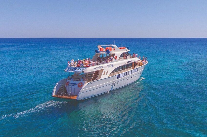 A white cruise ship named 'Medusa Cruises' sailing on clear blue waters. 3