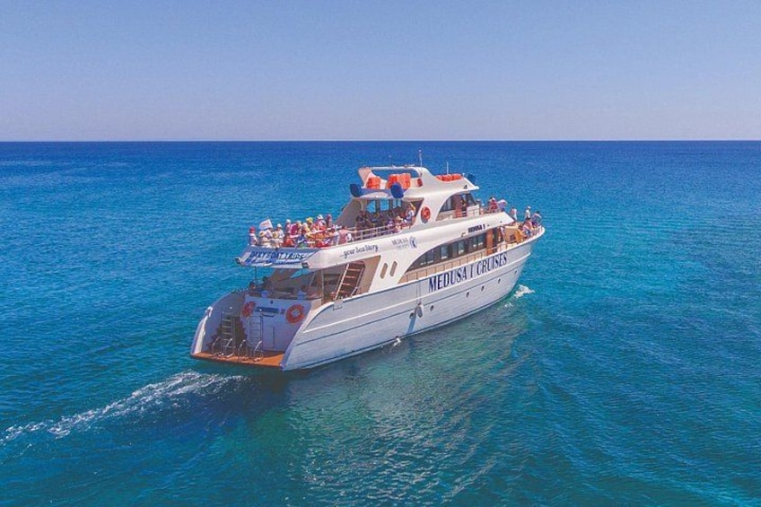A white cruise ship named 'Medusa Cruises' sailing on clear blue waters. 4