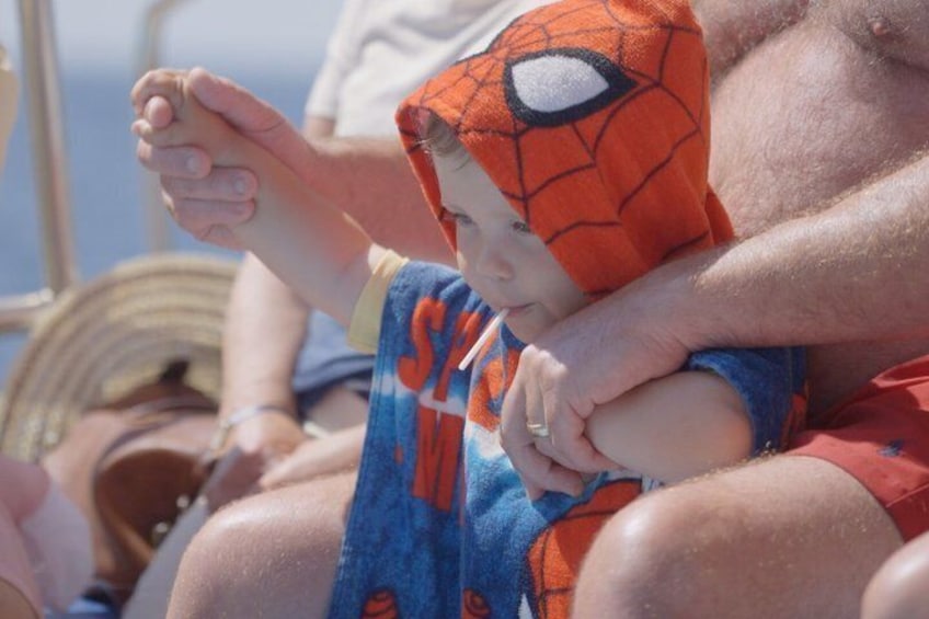 A person holding a child wearing a Spider-Man costume. 2