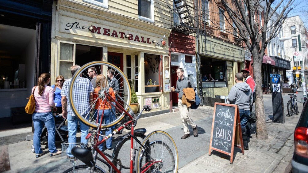 Une scène de rue avec un vélo garé devant un magasin appelé « The Meatball Shop ». 4