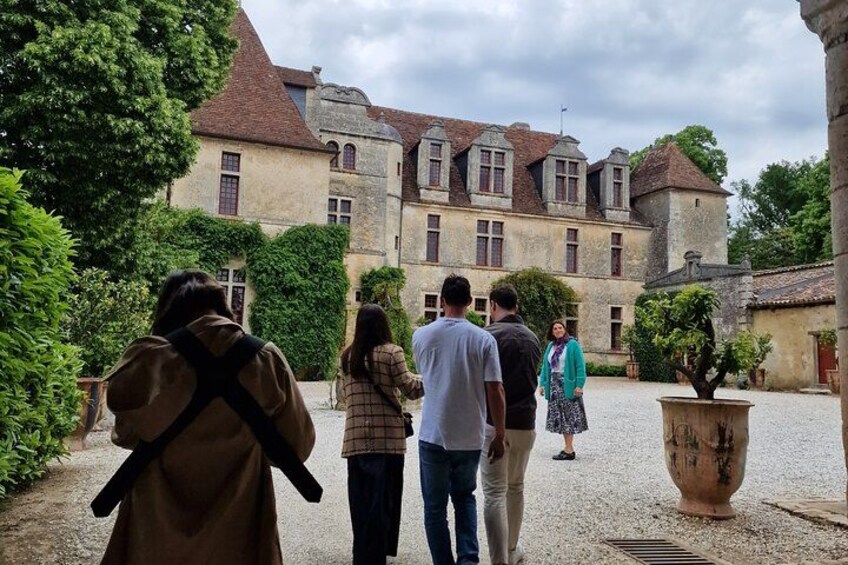 A historic building with a courtyard, surrounded by greenery. 2
