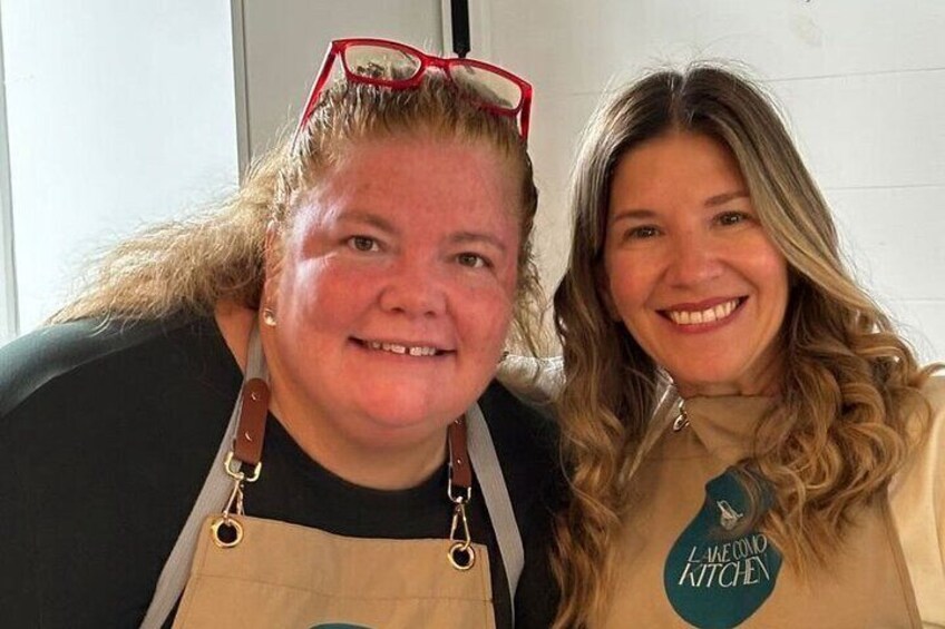 Two people wearing aprons with the logo "LAKEWOOD KITCHEN". 2