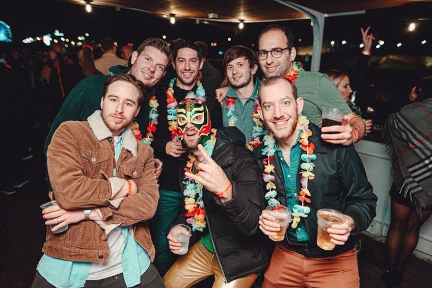 A group of people at a social event, some wearing colorful leis. 2