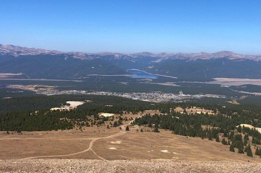 A mountainous landscape with a lake, forested areas, and a small town. 4