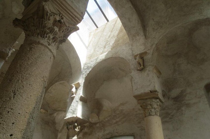 An interior with arched ceilings and columns. 3