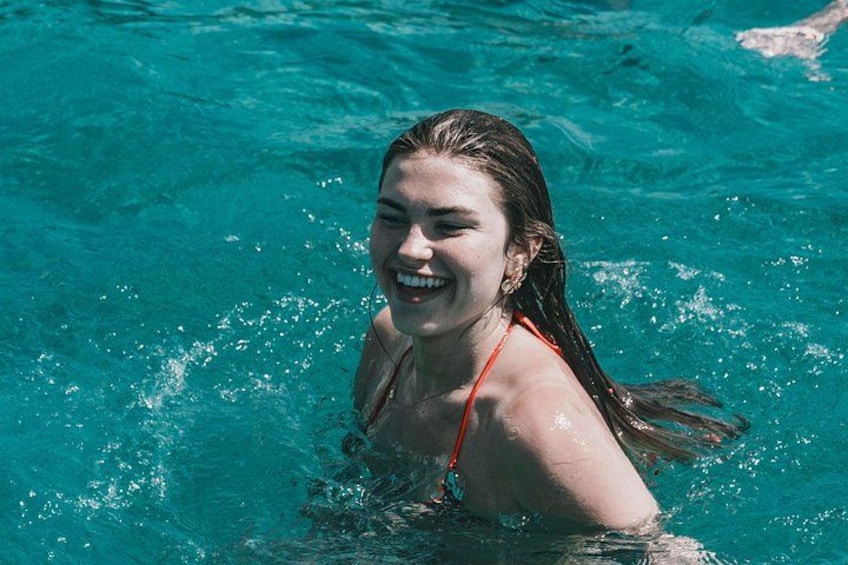 A person in a swimming pool with clear blue water. 5
