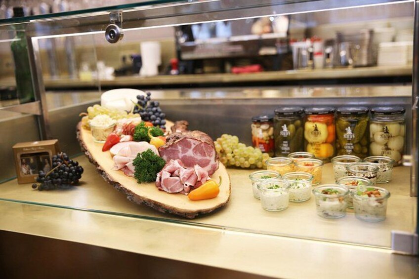 A charcuterie board with various meats, cheeses, and fruits. 2