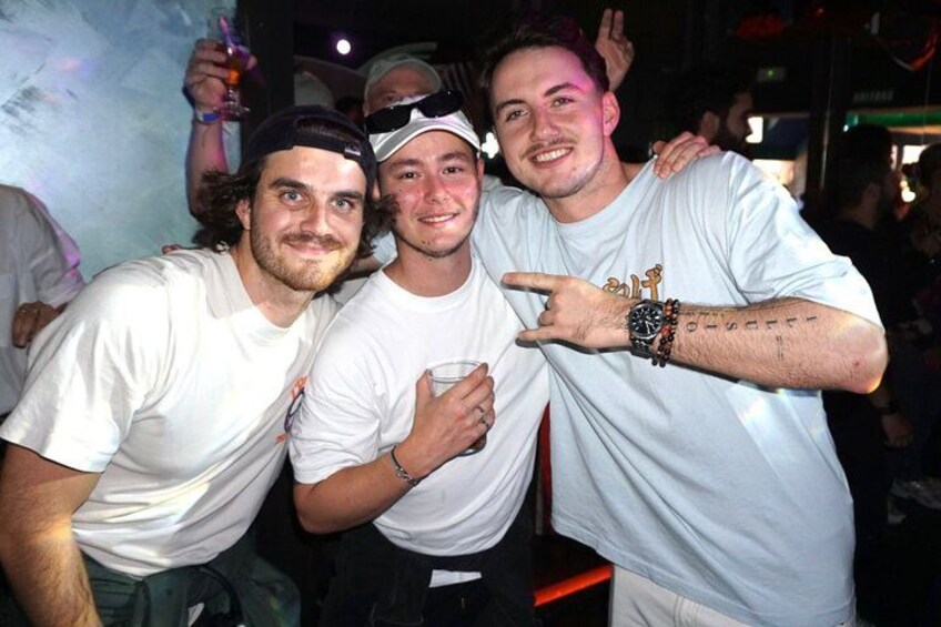 Three people posing together at a social event. 5