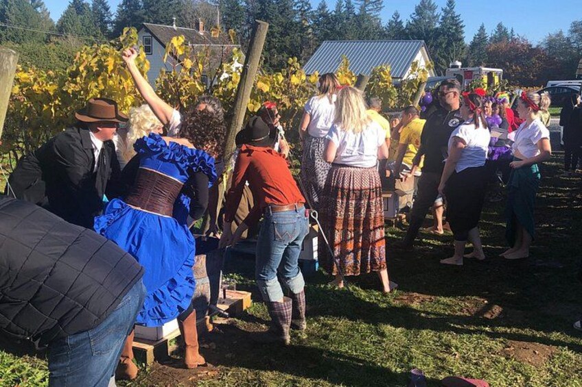 People in historical costumes, a vineyard, and a rural setting. 4