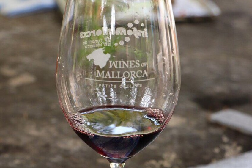 A wine glass with the inscription "Wines of Mallorca" and "Pats de Mallorca." 4