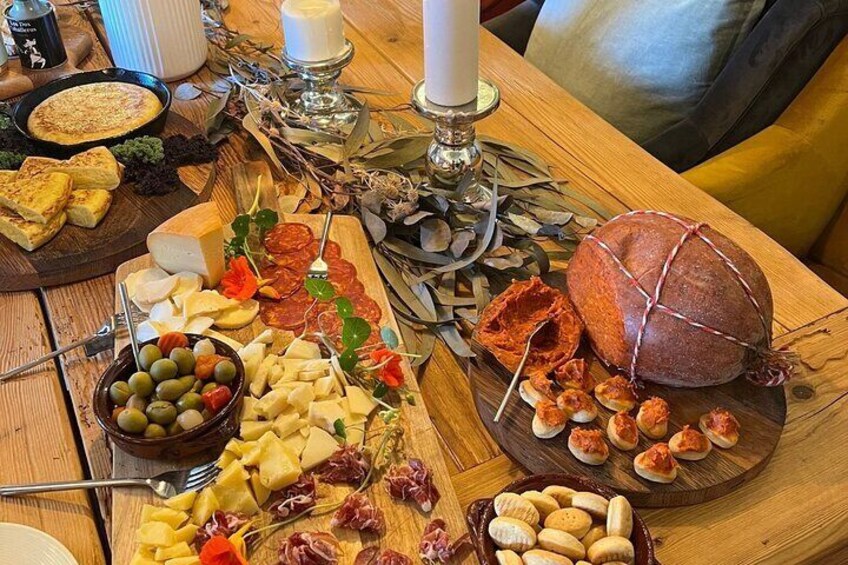 A charcuterie board with various cheeses, cured meats, olives, and bread. 2