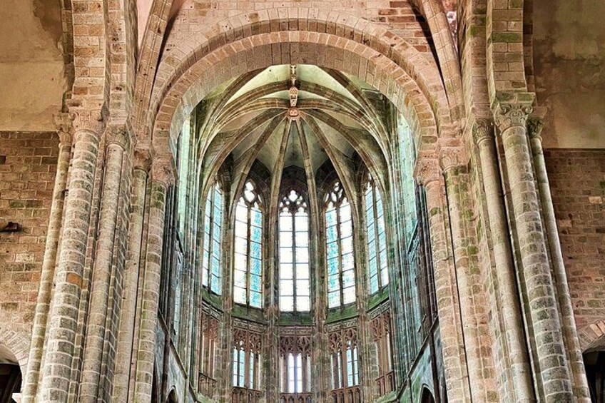A Gothic-style cathedral interior with arched windows and stone columns. 2