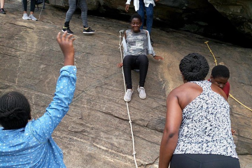 People on a rocky surface with ropes. 3