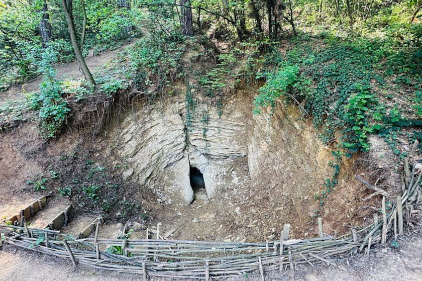 A large sinkhole surrounded by a wooden fence. 3