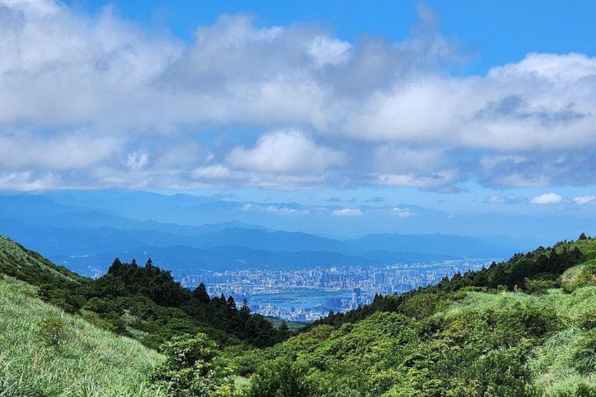 A cityscape with mountains in the background and a clear sky. 3