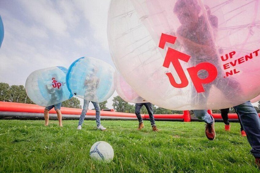 Des gens jouent avec de gros ballons gonflables sur un terrain herbeux. 2