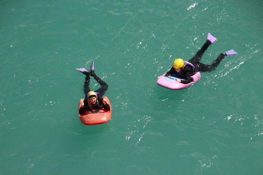 Two people floating on water using inflatable tubes. 4