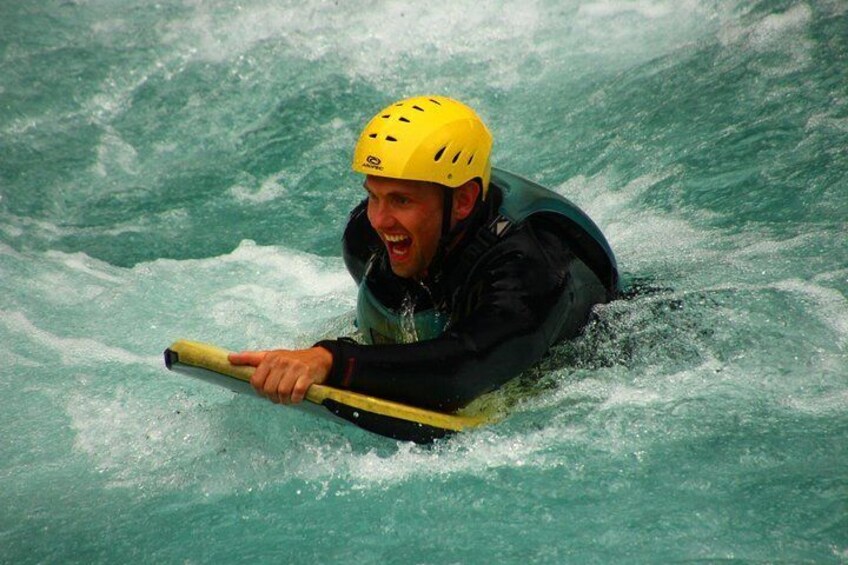 A person kayaking in turbulent water. 5