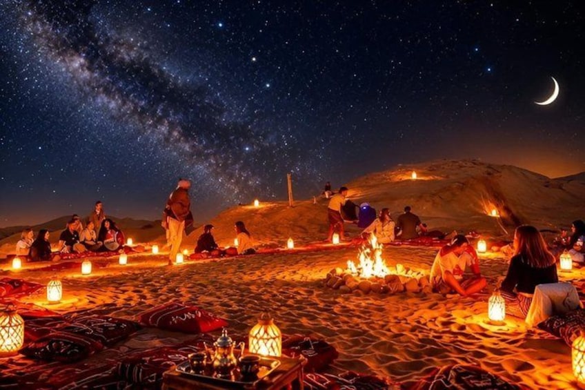 A desert night scene with people gathered around fires, under a starry sky. 1