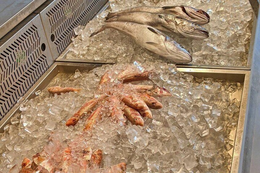 A variety of seafood on ice, including fish and shrimp. 3