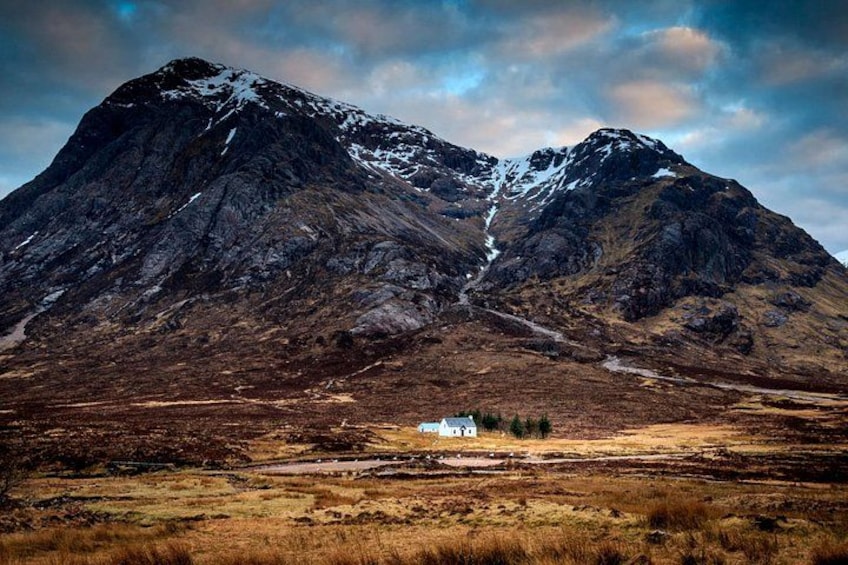 A mountain with a small house in a valley. 5