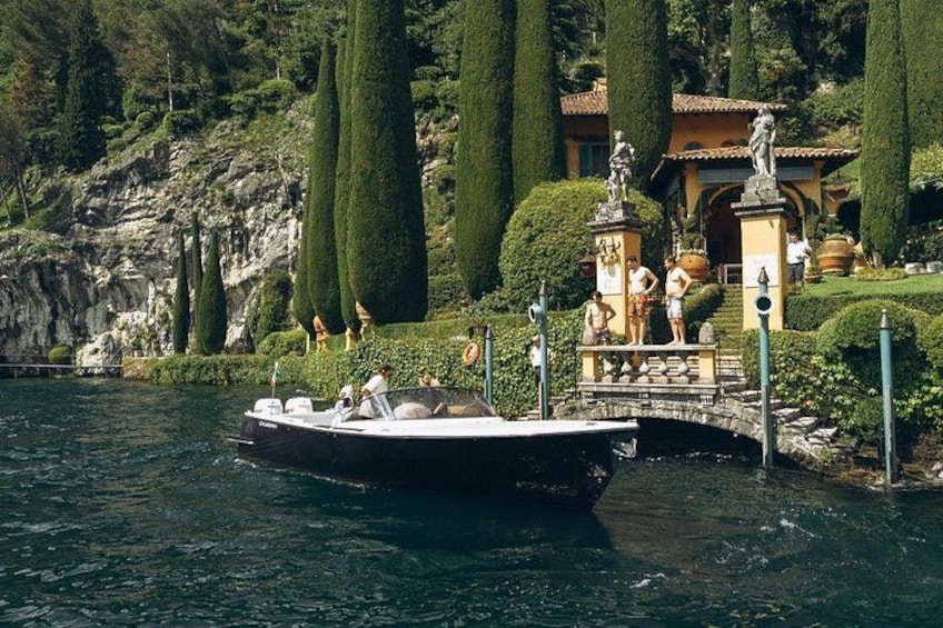 A boat on water, a bridge, and a building with statues. 3