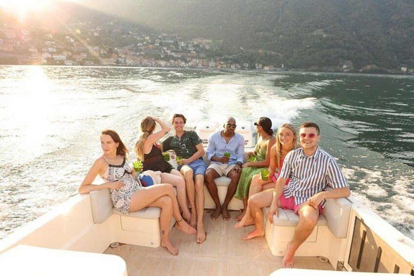 A group of people on a boat with a body of water and a distant shoreline in the background. 2