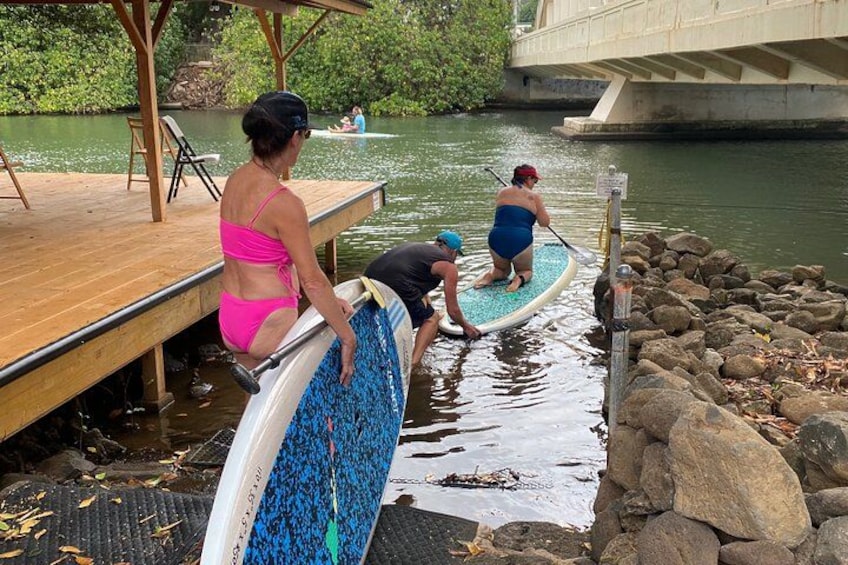 People on a paddleboard near a dock. 3
