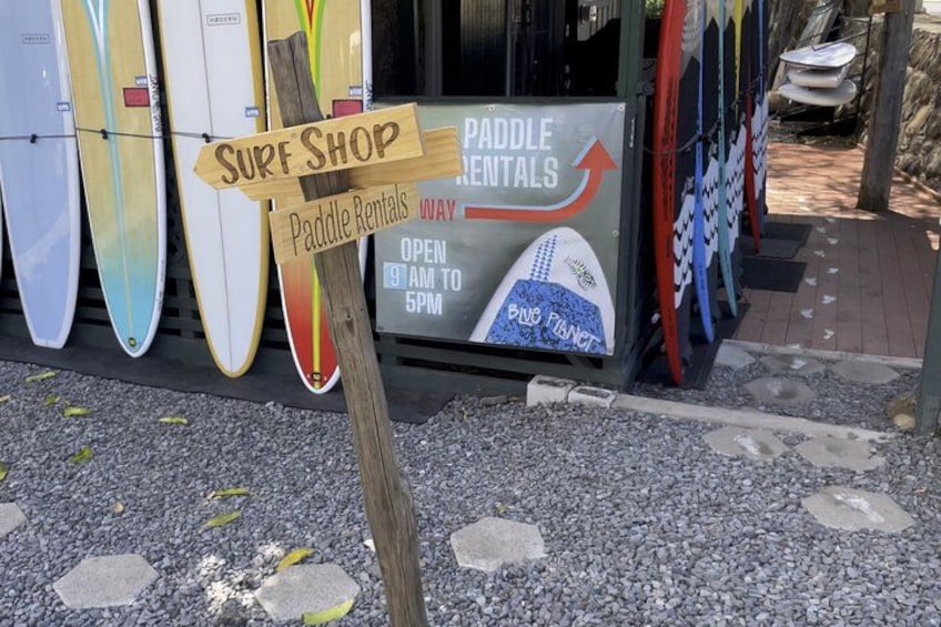 A surf shop with paddle rentals, open from 9 AM to 5 PM. 2