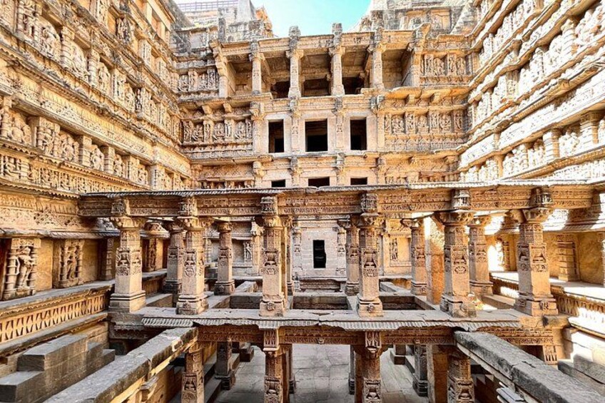 An intricately carved temple with multiple levels and detailed stonework. 1