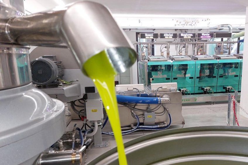 A machine with a green liquid being dispensed into a container. 1