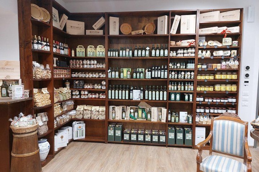 A room with wooden shelves filled with various bottles and boxes, a striped chair, and a wooden floor. 4