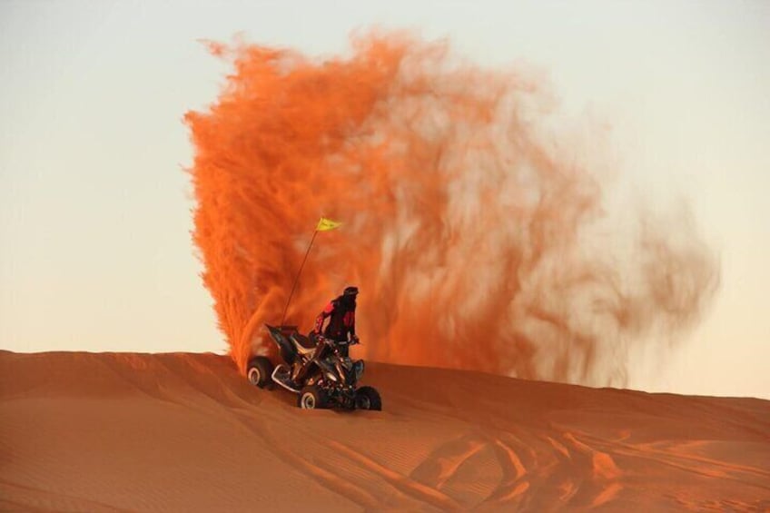 A person riding a dune buggy on a sandy dune. 2