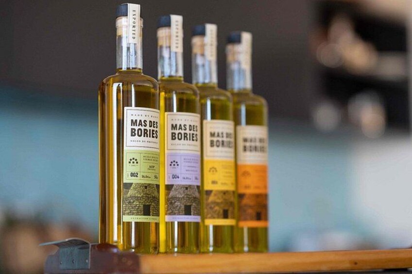 Four bottles of Mas Des Bories wine on a wooden surface. 5