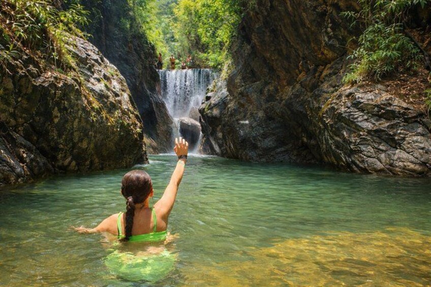 A waterfall in a rocky gorge with clear water. 1