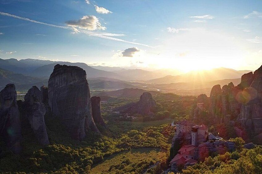A mountainous landscape with rock formations and a small building. 1
