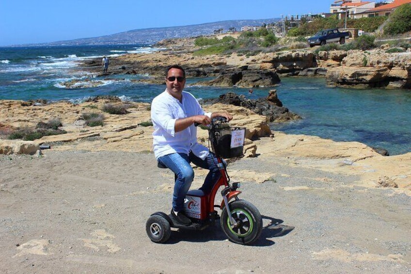 Une personne se déplace sur un Segway sur un sentier côtier rocheux, avec l’océan en arrière-plan. 3