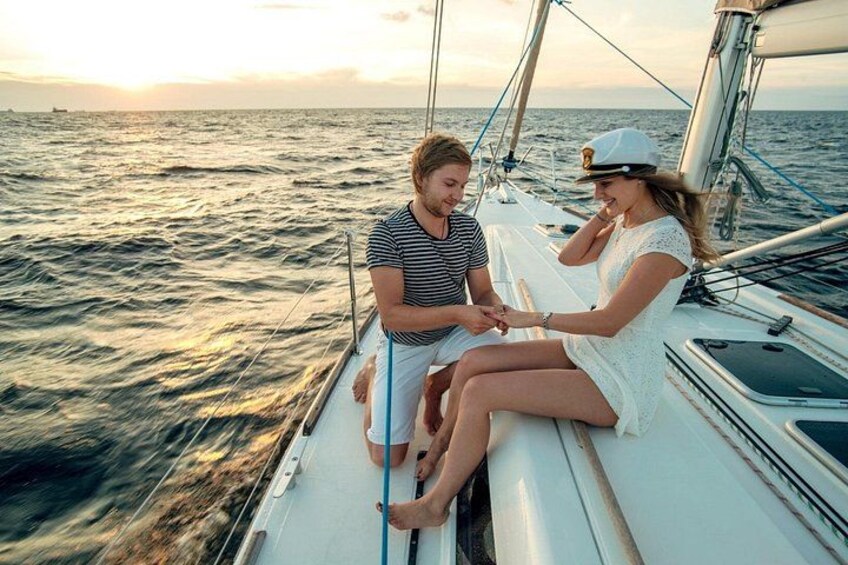 A couple on a sailboat at sunset. 3