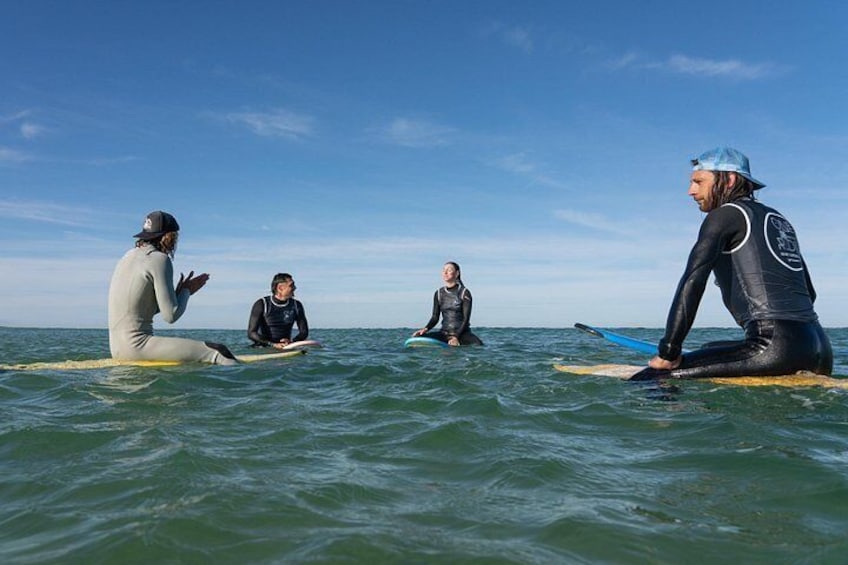 Three people on surfboards in the ocean. 2